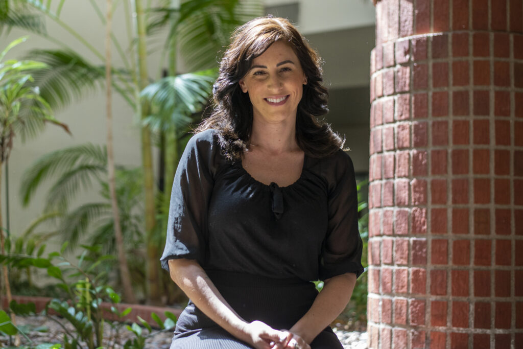 Image description: Portrait of Mindy Browne beside a garden. End of alt text. 