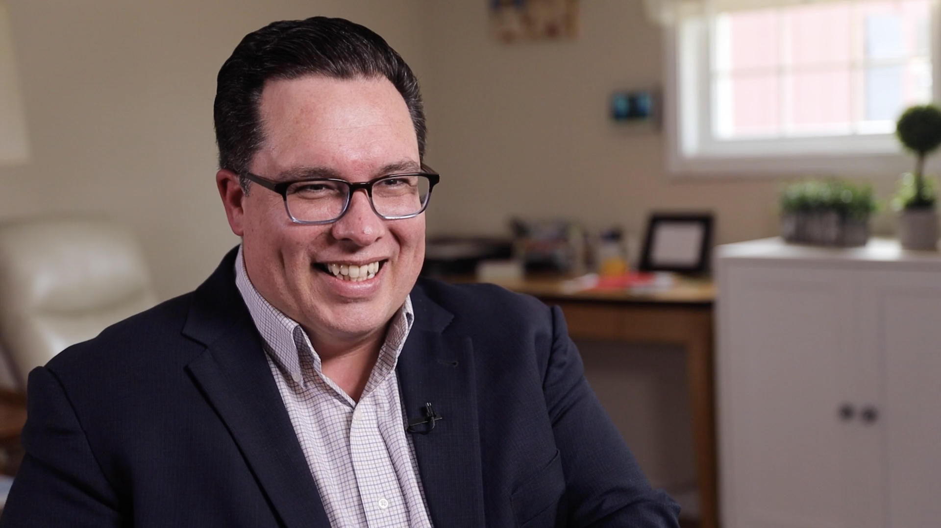 Image description: Head-and-shoulders portrait of Marc Fafard, smiling, sat in a home office. End of alt text.
